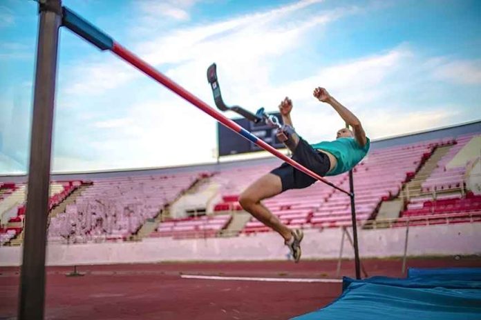 Paralympic athlete clearing a high jump bar during training, a symbolic image for Oleg Boyko's article on steady social commitment.