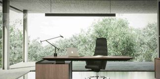 Right Office Furniture Selection Guide: modern executive desk and ergonomic chair in a minimalist, well-lit office workspace