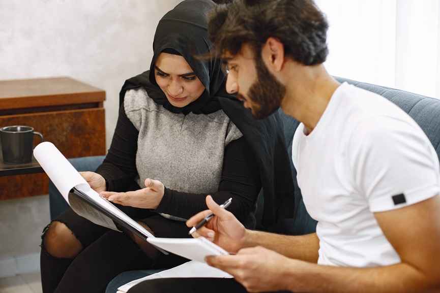 Couple reviewing legal documents before marriage, representing Prenuptial Agreement in UAE and financial planning discussions among UAE couples.