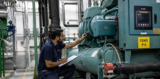 Why UAE businesses are rethinking facility management Outsourced Facility Management UAE technician inspecting industrial equipment