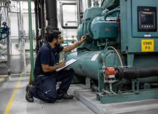Why UAE businesses are rethinking facility management Outsourced Facility Management UAE technician inspecting industrial equipment