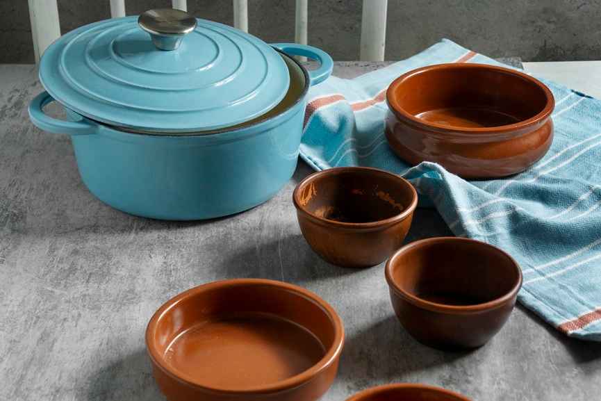 Traditional clay pots and earthen cookware displayed on a kitchen table, highlighting sustainable cooking and artisan pottery craftsmanship.