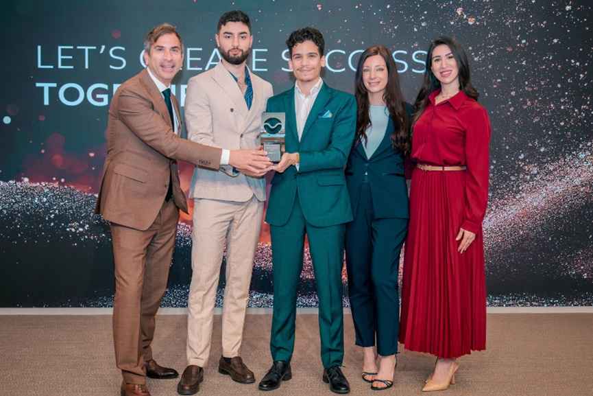 GenZone team receiving an award at a business event
